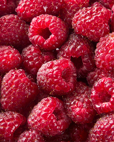 Close-up of fresh raspberries with a vibrant red color.