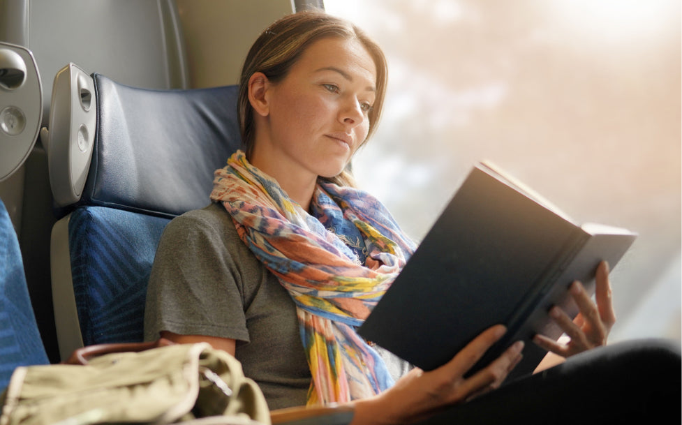 Woman reading a book on a train