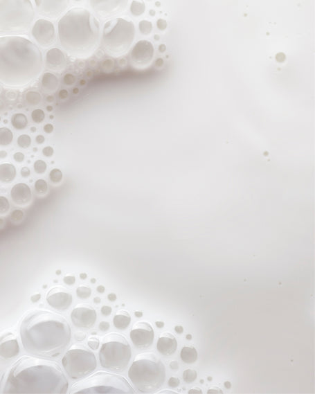 Close up of white milk with bubbles.