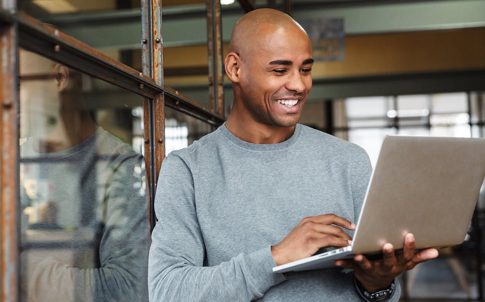 Man using a laptop in an indoor setting