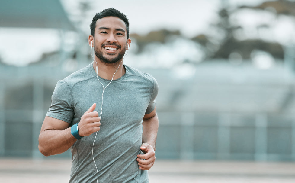 Man jogging outdoors with a blurred background
