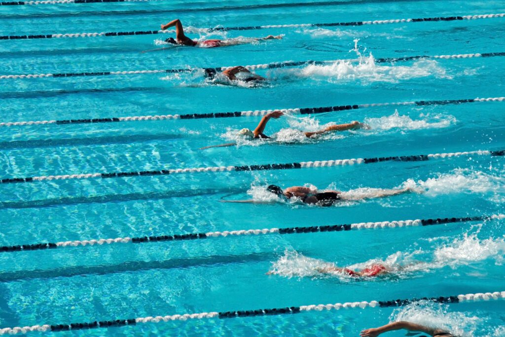 The swimmers competing at a high school meet strive for victory